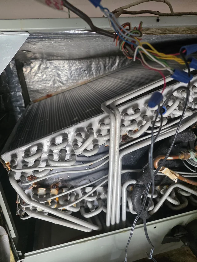 Interior heating and cooling coils being inspected for repair
